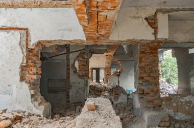 Explore the decaying ruins of an abandoned building with exposed bricks and destruction.